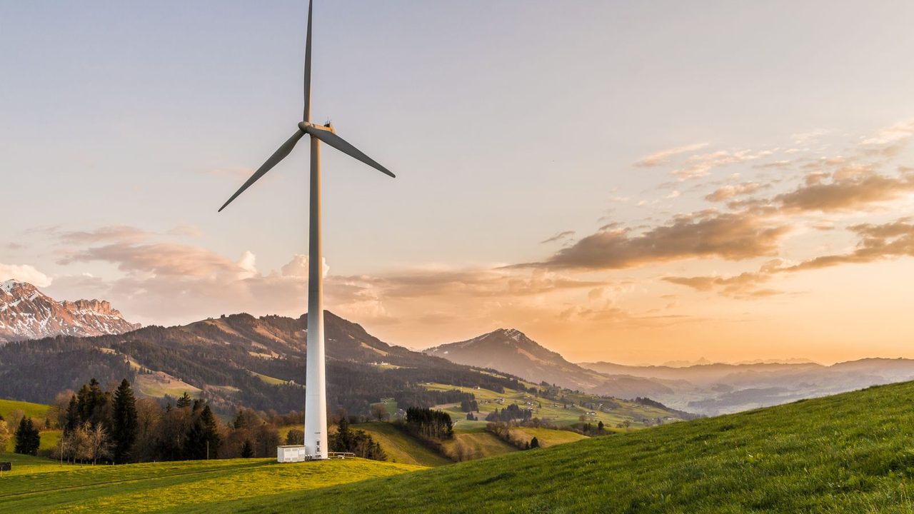 Wind turbines in an open weather field.